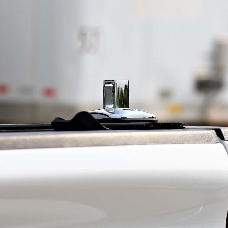 Close-up of Putco chrome stake pocket tie down anchor on pickup truck bed, designed for cargo security.