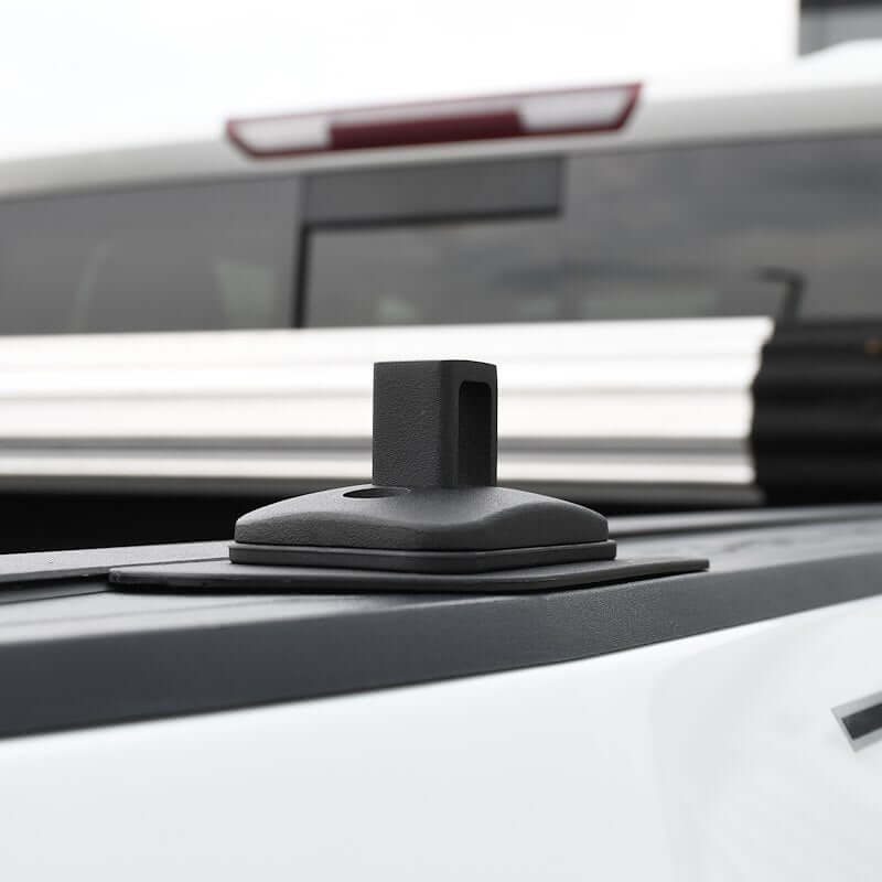 Putco black stake pocket tie-down anchor for pickup trucks, designed for 2015-2025 models, mounted on a truck bed.