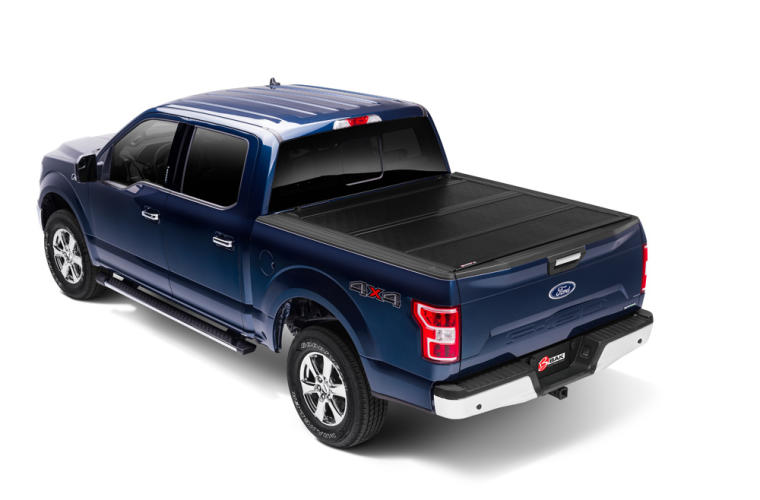 Pickup truck with a hard folding tonneau cover closed over the bed