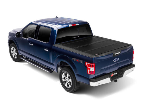 Pickup truck with a hard folding tonneau cover closed over the bed