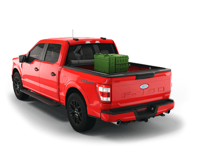 Red Ford F-150 with gear in the truck bed and the Sawtooth Stretch tonneau cover rolled up at cab 