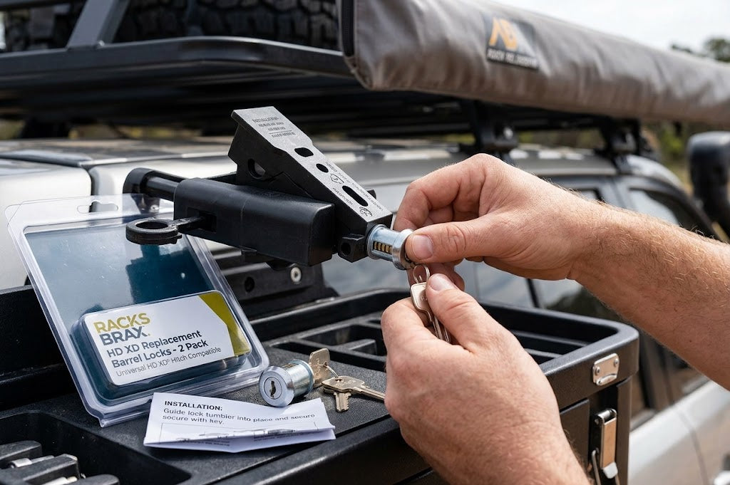 RacksBrax HD XD lock tumbler being installed in a vehicle hitch with replacement keys and instructions.