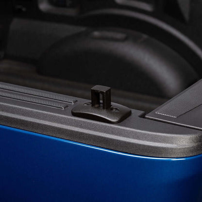 Putco black stake pocket tie-down anchor installed on a pickup truck bed, showcasing rugged design and easy access.
