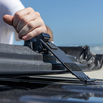 Jeep JT Gladiator Freedom Panel storage mechanism being adjusted on vehicle roof with hand.