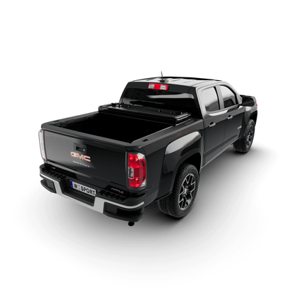 hard aluminum tonneau cover for Chevrolet Colorado shown on black GMC Canyon truck from rear view.